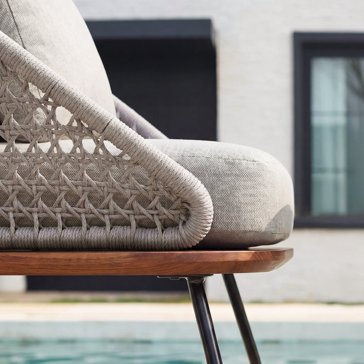 The chair side combines a wrapped outer rail with an open woven lattice panel
