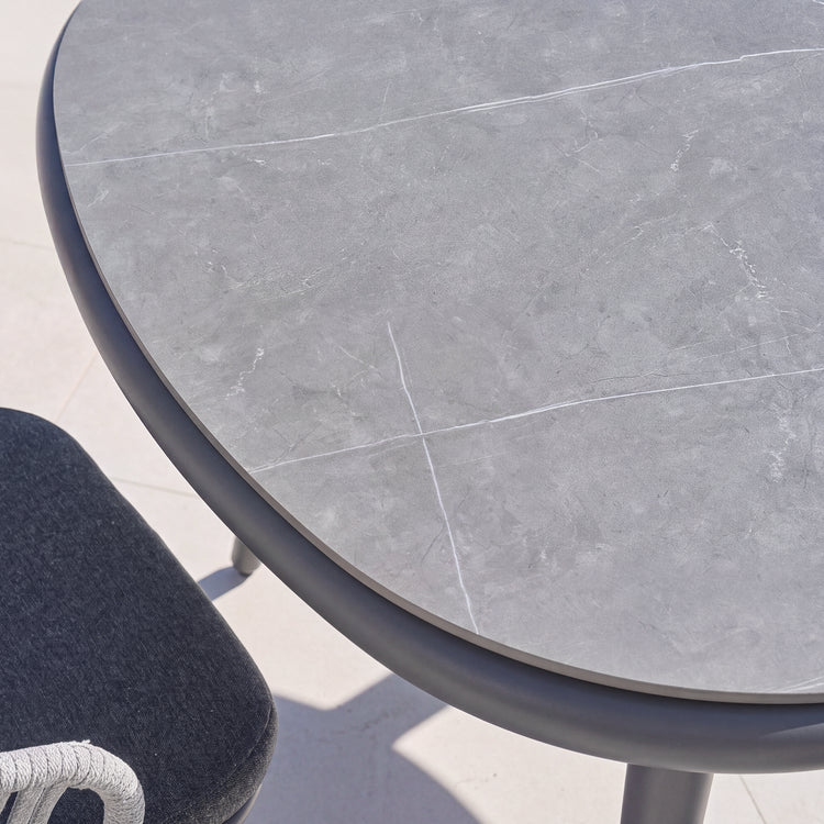 Gray round tabletop with pale linear veining in close-up