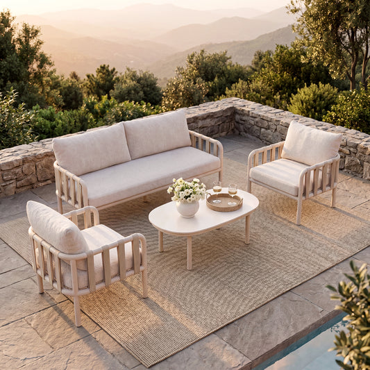 Cream patio set includes a sofa, two chairs, and table, The seating overlooks sunlit mountains