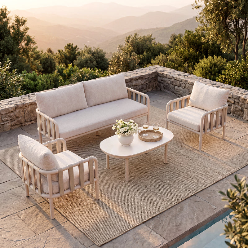 Cream patio set includes a sofa, two chairs, and table, The seating overlooks sunlit mountains