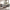 Gray reclining sofa and loveseat have two footrests extended in a bright living room