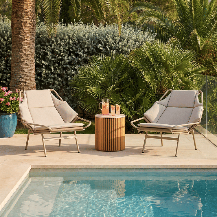 Two outdoor lounge chairs shown beside a pool