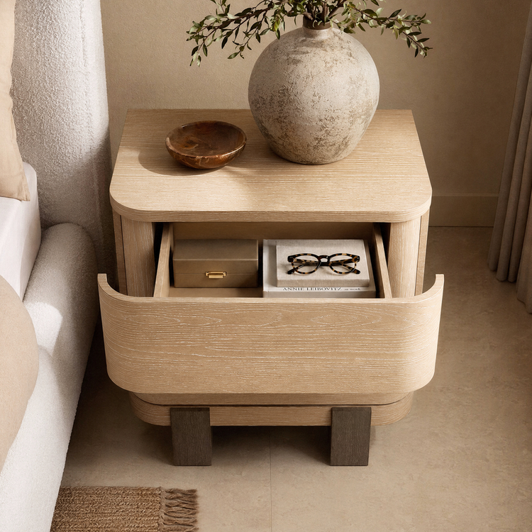 Light wood-toned curved-drawer nightstand shown open