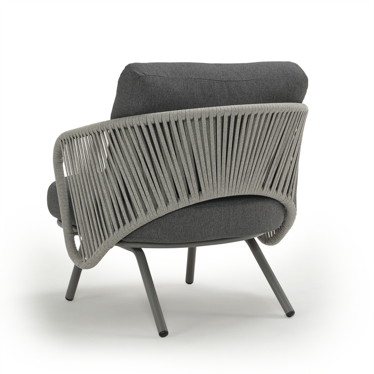 Rear view of an armchair with vertical back bands and four splayed legs