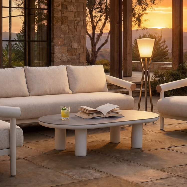 A low oval coffee table with four cylindrical supports occupies the foreground