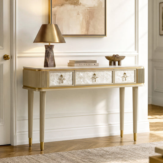 Narrow console table has three textured drawer fronts, ribbed ends, and four slim legs