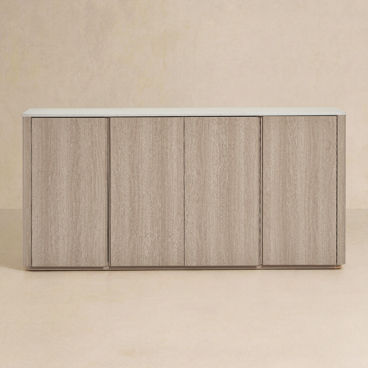 Wide cabinet has four front doors, Pale wood-grain finish surrounds a light slab top