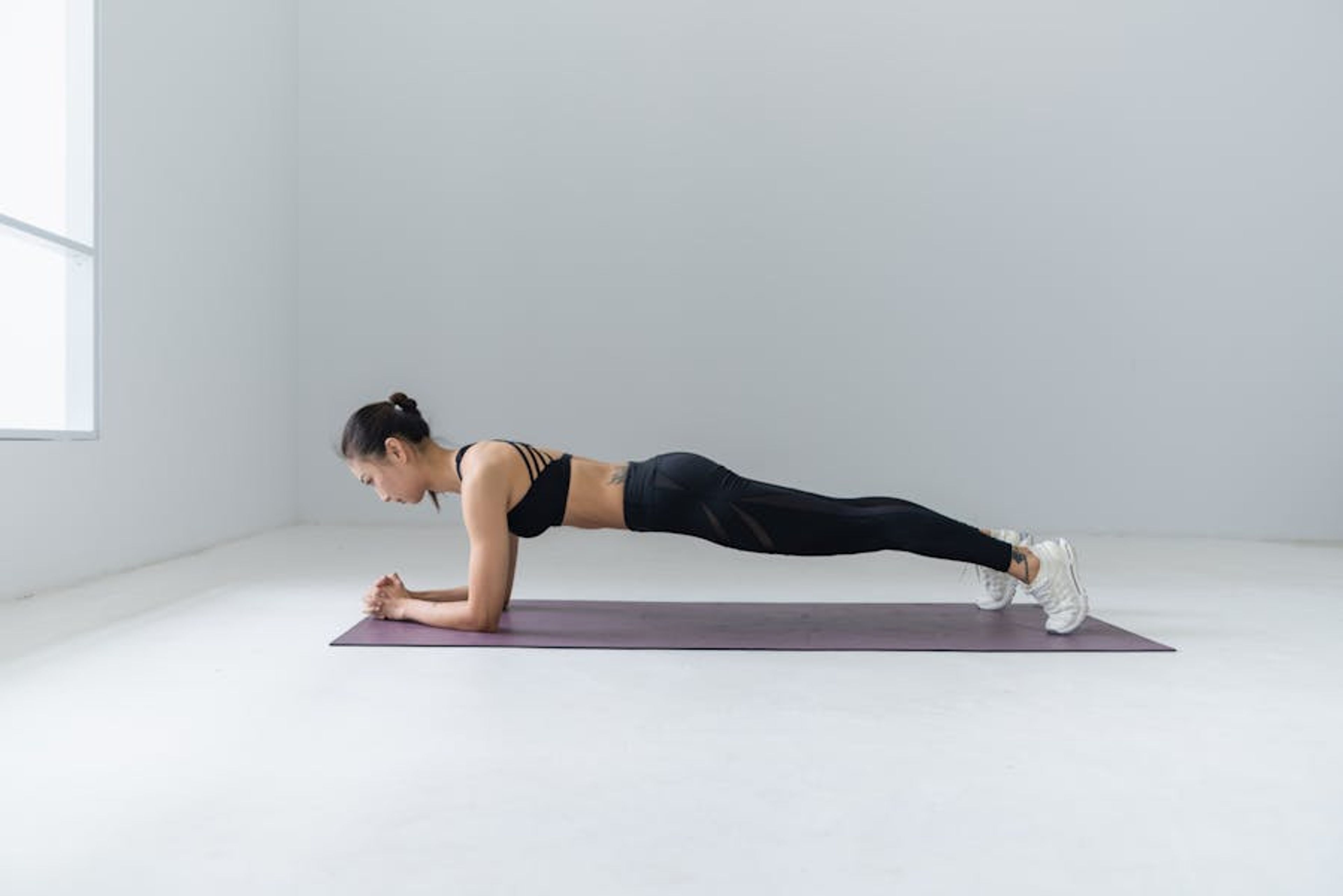 Yoga class in a studio with wooden floors