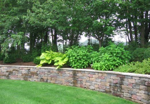 Segmental block retaining wall with steps and plantings