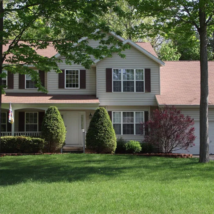Front yard landscape with lush lawn and plantings