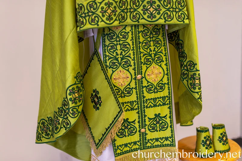 Lime green Greek-style priest vestment set with dark green scrollwork embroidery, gold cross motifs, matching belt and orarion with gold fringe