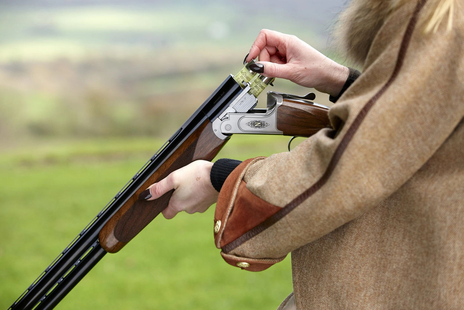 Woman shooting an Antonio Zoli over-under in the field