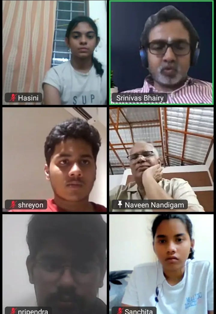 professional career coach explaining colorful mind map and reports to family around table, warm office setting