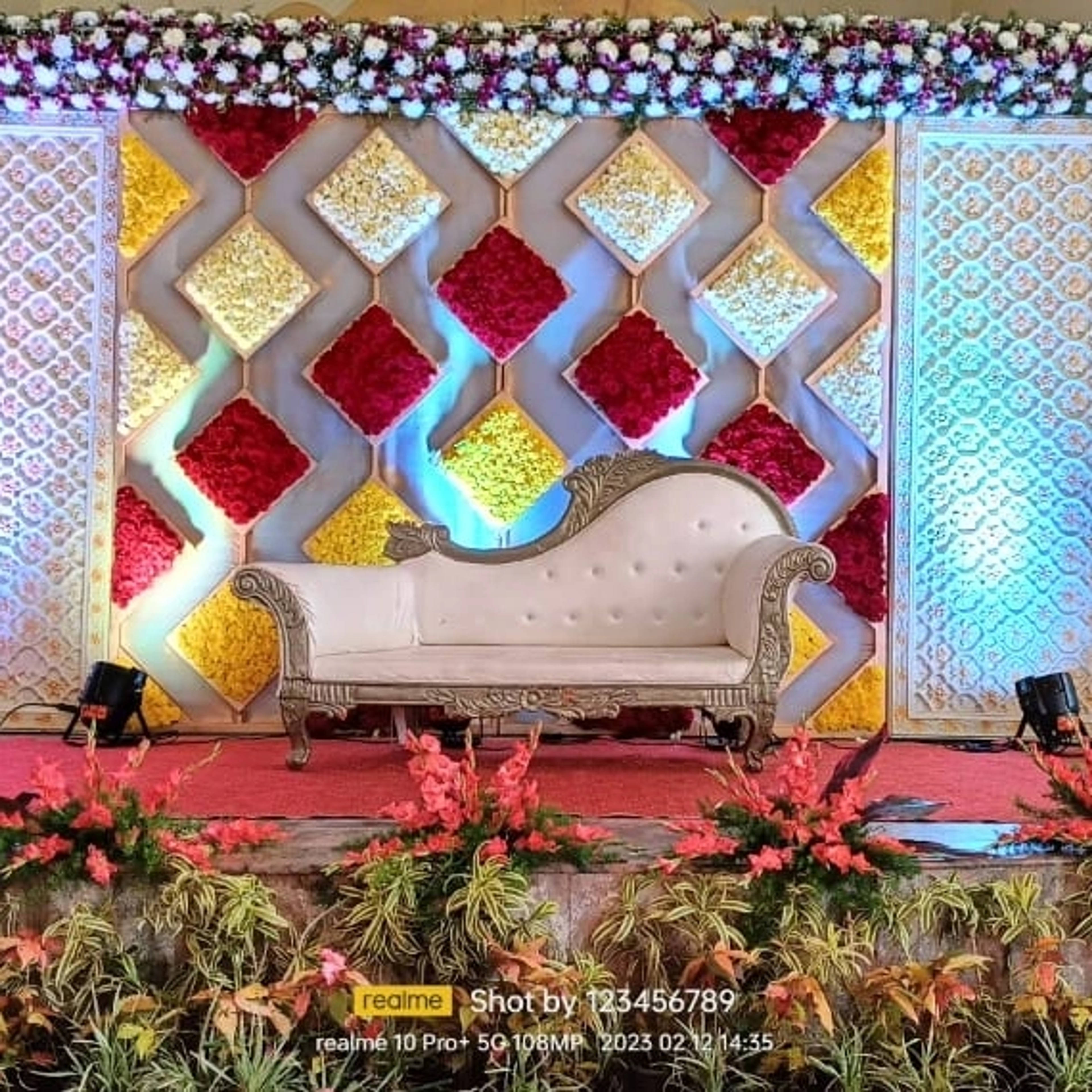 Diamond-lattice flower backdrop in yellow and red with a settee