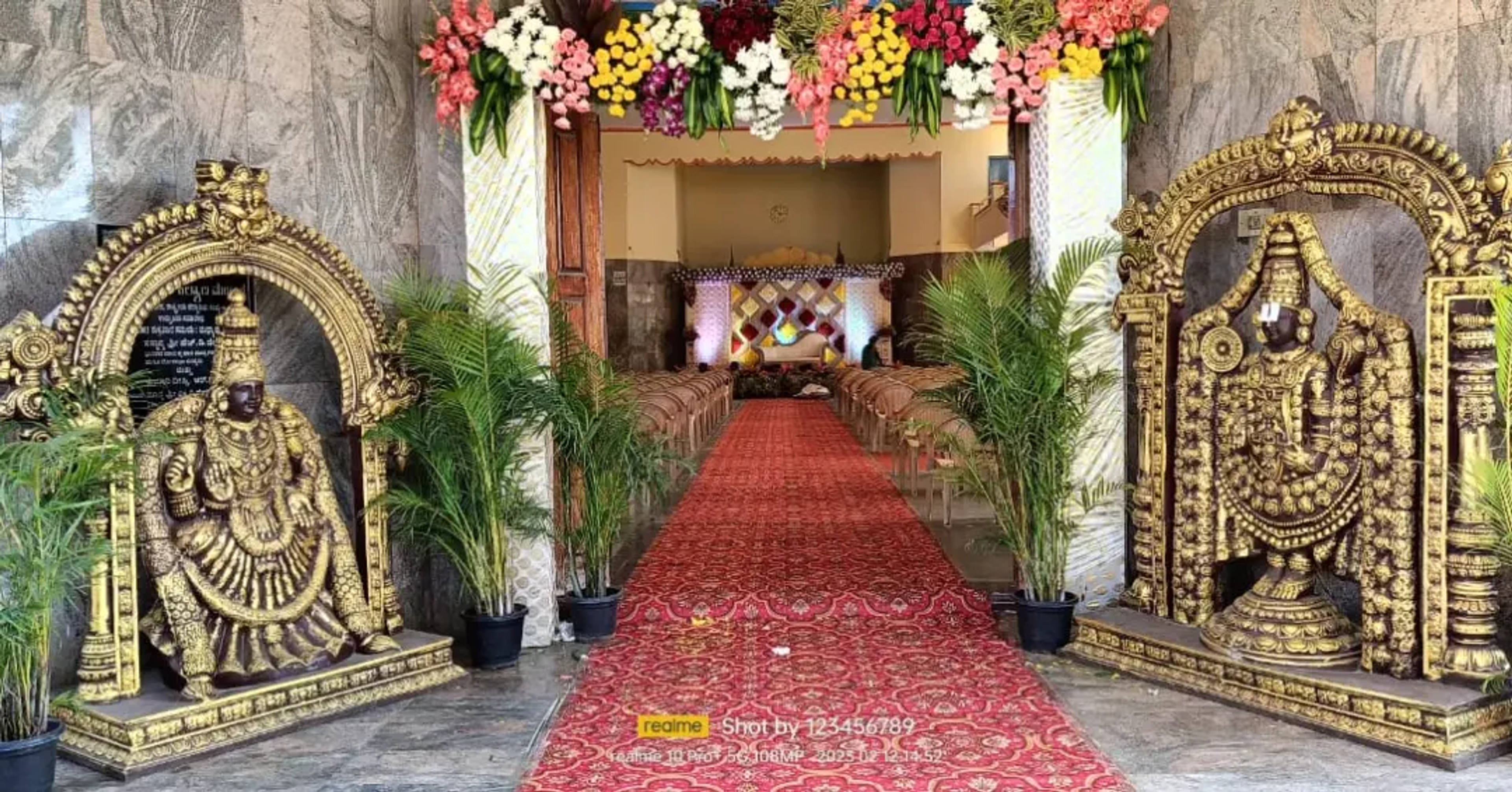 Brass Venkateshwara gateway framing a red-carpet entrance