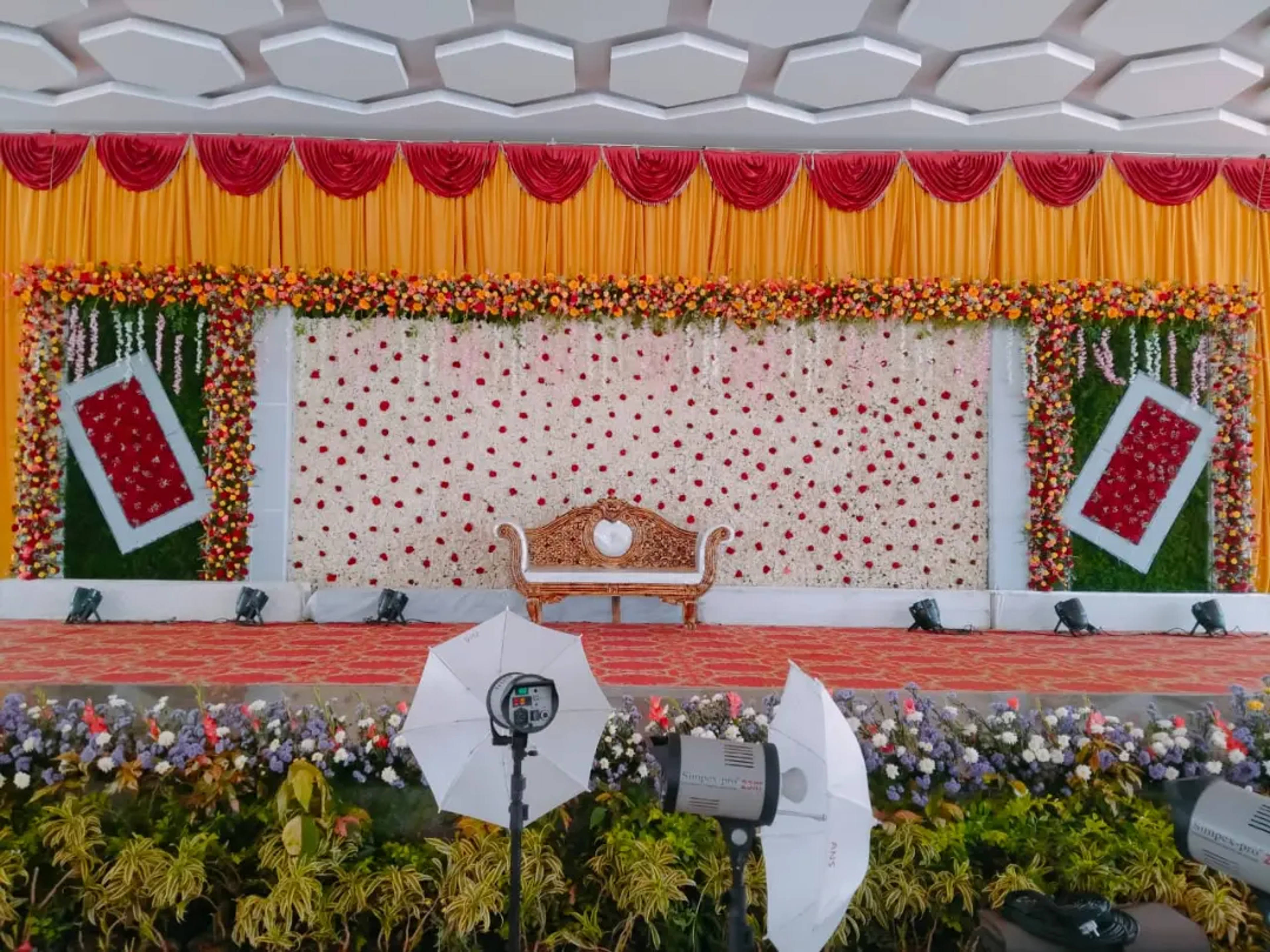 Rose-curtain stage with a marigold pelmet and a carved settee