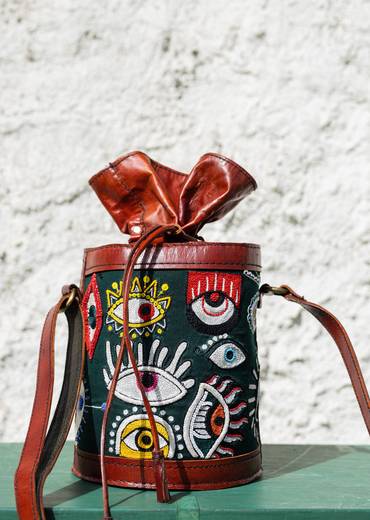 Handcrafted leather potli bag with bold colourful eye embroidery