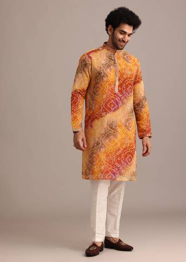 Sunny Festive Couple Set – Yellow Organza Floral Saree With Beaded Border For Her And Orange Tie-Dye Jacket Kurta Set With Mirror Work For Him