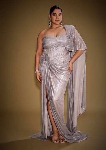 Gold One Shoulder Drape Gown With Embroidered Floral Brooch And Trail