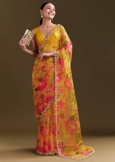Sunny Festive Couple Set – Yellow Organza Floral Saree With Beaded Border For Her And Orange Tie-Dye Jacket Kurta Set With Mirror Work For Him