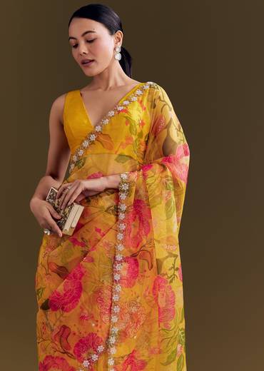 Sunny Festive Couple Set – Yellow Organza Floral Saree With Beaded Border For Her And Orange Tie-Dye Jacket Kurta Set With Mirror Work For Him