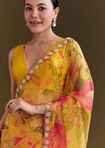 Sunny Festive Couple Set – Yellow Organza Floral Saree With Beaded Border For Her And Orange Tie-Dye Jacket Kurta Set With Mirror Work For Him