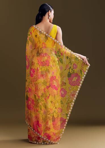 Sunny Festive Couple Set – Yellow Organza Floral Saree With Beaded Border For Her And Orange Tie-Dye Jacket Kurta Set With Mirror Work For Him