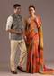 Sunlit Festive Couple Set – Orange Abstract Crush Saree for Her And Olive Silk Kurta Jacket Set for Him