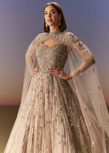Beige Gown With Shoulder Cape And Rich Vertical Embroidery