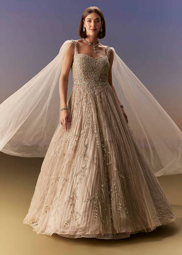 Gold Gown With Pleated Panels And Dramatic Cape