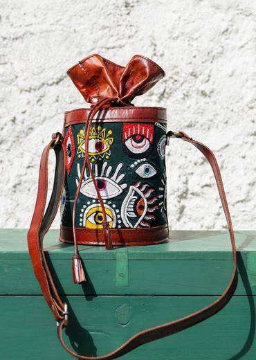 Handcrafted leather potli bag with bold colourful eye embroidery