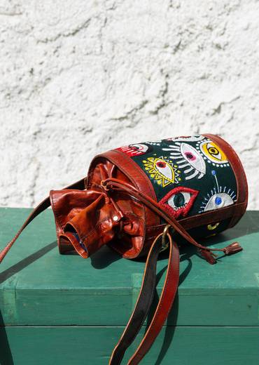 Handcrafted leather potli bag with bold colourful eye embroidery