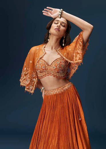 Rust Orange Embroidered Lehenga With Dramatic Cape And Blouse
