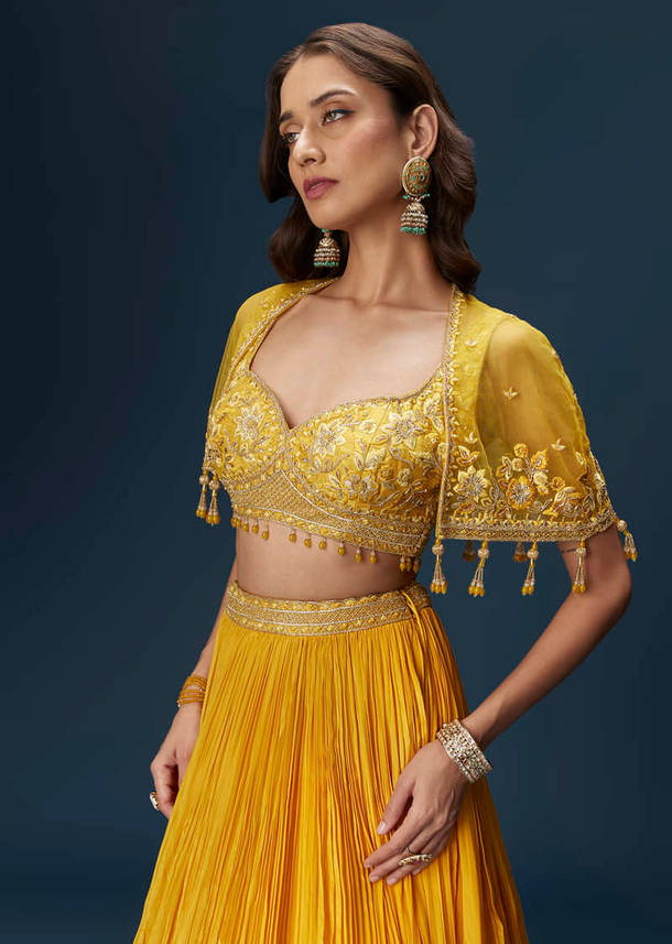 Yellow Bridesmaid Lehenga With Sleeveless Blouse And Draped Cape