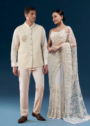 Elegant Wedding Couple Set – White Floral Heavy Embroidered Net Saree For Her And Off-White Embroidered Silk Kurta Jacket Set For Him