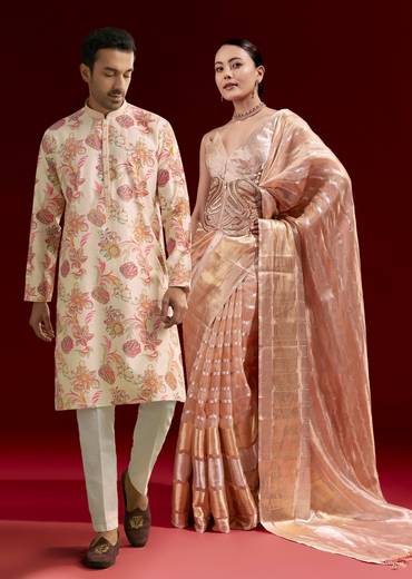 Elegant Festive Couple Set – Peach Banarasi Tissue Saree with Cutdana Belt for Her And Off-White Silk Motif Kurta Set for Him