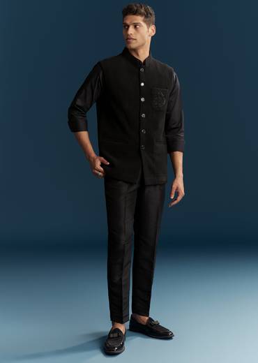 Bold Evening Couple Set – Black Heavy Embroidered Net Saree With Cutwork Border For Her And Black Embroidered Corduroy Shirt Jacket For Him