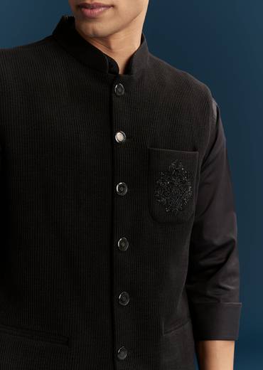 Bold Evening Couple Set – Black Heavy Embroidered Net Saree With Cutwork Border For Her And Black Embroidered Corduroy Shirt Jacket For Him