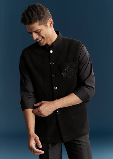 Bold Evening Couple Set – Black Heavy Embroidered Net Saree With Cutwork Border For Her And Black Embroidered Corduroy Shirt Jacket For Him