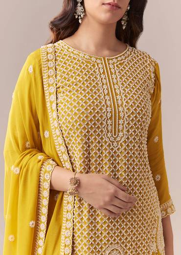Mustard Yellow Coordinated Attire – Embellished Sharara Suit For Her And Yellow Silk Mirror Work Kurta Set For Him