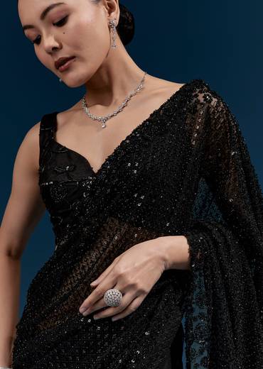 Bold Evening Couple Set – Black Heavy Embroidered Net Saree With Cutwork Border For Her And Black Embroidered Corduroy Shirt Jacket For Him