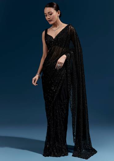 Bold Evening Couple Set – Black Heavy Embroidered Net Saree With Cutwork Border For Her And Black Embroidered Corduroy Shirt Jacket For Him