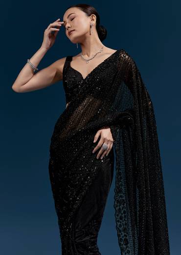 Bold Evening Couple Set – Black Heavy Embroidered Net Saree With Cutwork Border For Her And Black Embroidered Corduroy Shirt Jacket For Him