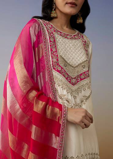 Classic Festive Couple Set – White Silk Palazzo Suit With Moti Zardosi Work For Her And Pink Silk Kurta Set With Mirror And Thread Work For Him