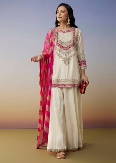 Classic Festive Couple Set – White Silk Palazzo Suit With Moti Zardosi Work For Her And Pink Silk Kurta Set With Mirror And Thread Work For Him