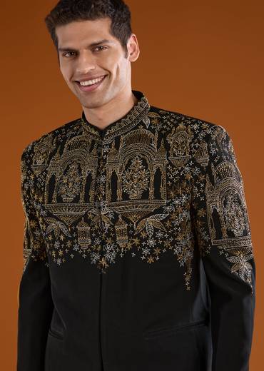 Bold Festive Couple Set – Black Silk Palazzo Suit With Zari Thread And Sequins Work For Her And Black Suiting Jodhpuri Pant Set With Embroidery For Him