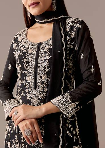 Midnight Black Royal Pair – Pakistani Style Palazzo Suit For Her And Black Silk Kurta With Embroidered Nehru Jacket For Him