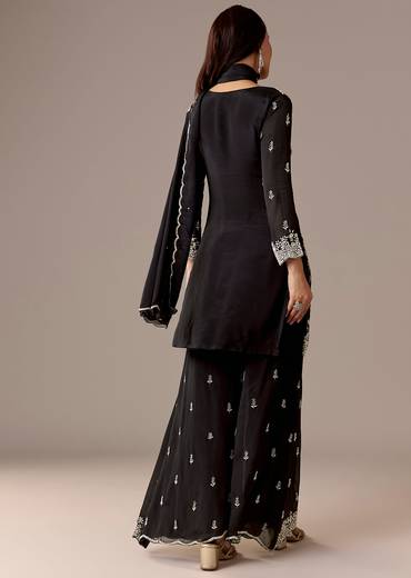 Midnight Black Royal Pair – Pakistani Style Palazzo Suit For Her And Black Silk Kurta With Embroidered Nehru Jacket For Him