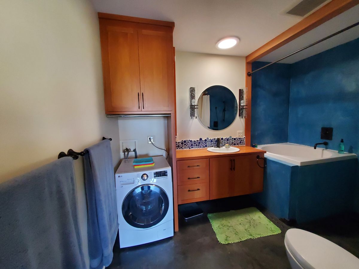Large bath w/ deep soaking tub, walk in shower, custom vanity & linen closet, & washing machine. Solatube w/ light kit provides lighting day or night.