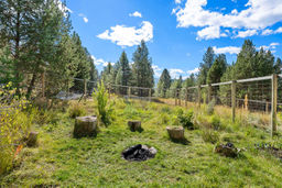 Firepit within fenced area.